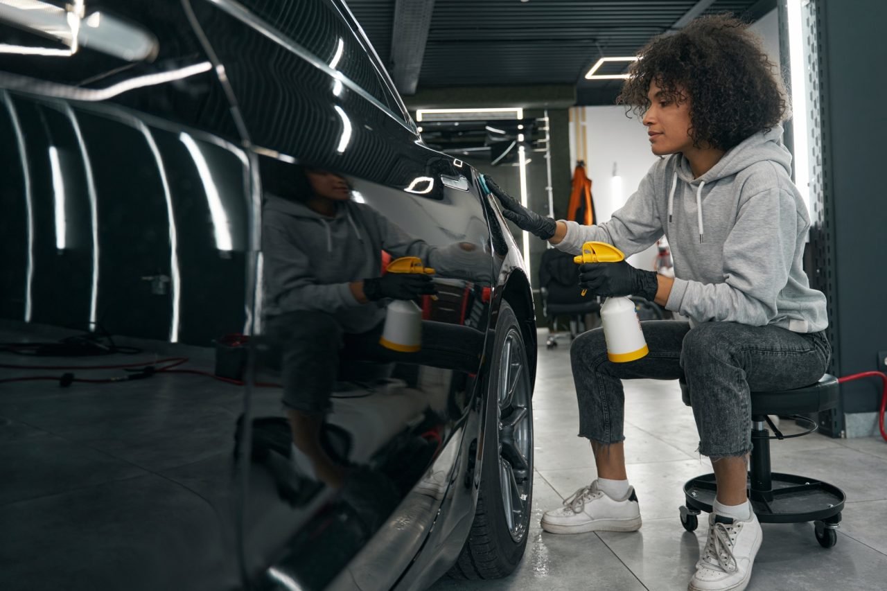 auto-detailer-removing-contaminants-from-car-exterior-surface.jpg