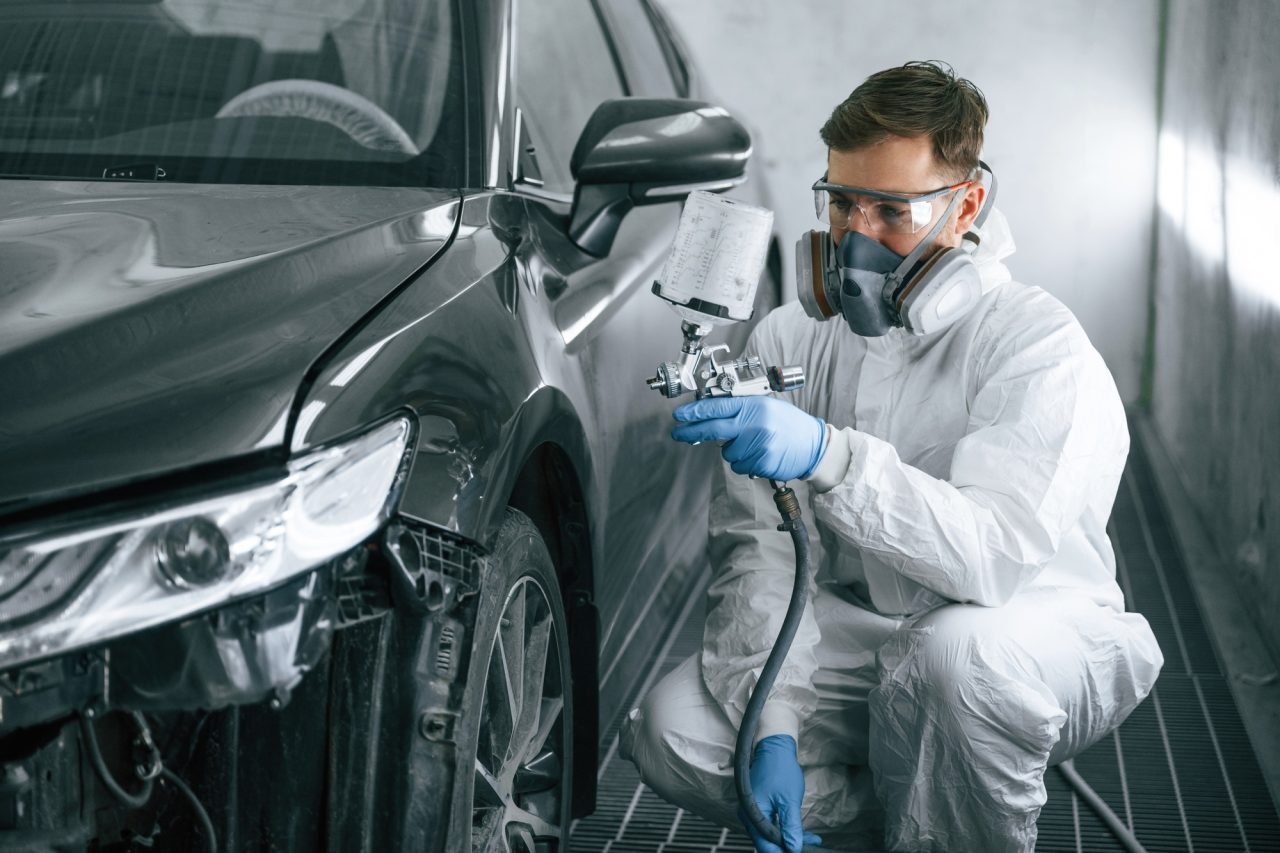 professional-worker-man-is-painting-a-car-by-using-spray-guy.jpg